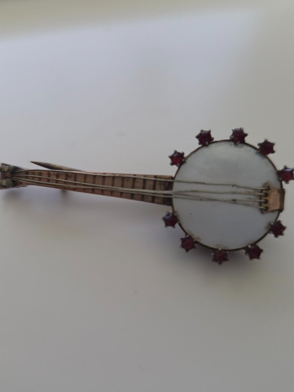 Vintage banjo/guitar pin brooch. Silver, hold, red stones, metal